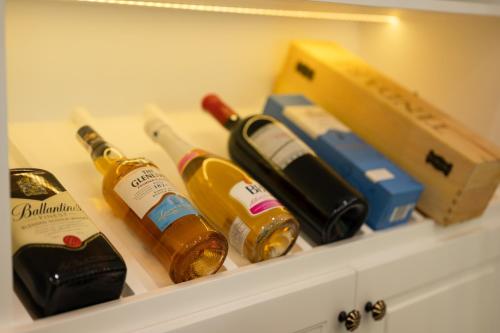 a cabinet with two bottles of champagne and a box at The View Hotel in Cam Lâm