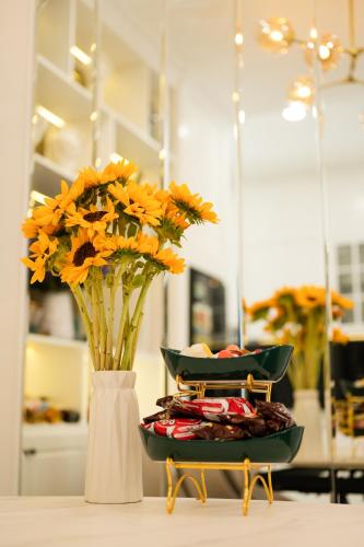 a vase filled with orange flowers sitting on a table at The View Hotel in Cam Lâm