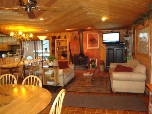 a living room with a couch and a table and a fireplace at Bristlecone Lodge in Woodland Park