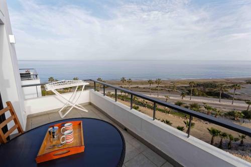 a balcony with a table and a view of the ocean at SPECTACULAR APRT. IN FRONT OF THE SEA in Mojácar