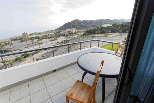 a balcony with a table and a view of the beach at SPECTACULAR APRT. IN FRONT OF THE SEA in Mojácar