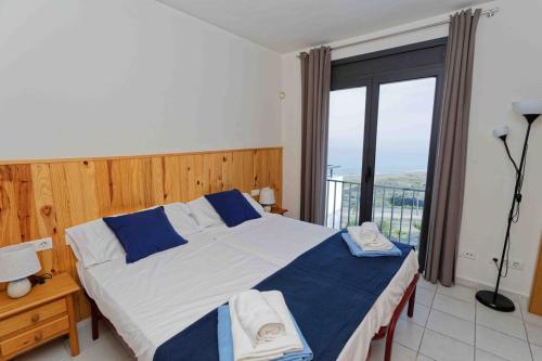 a bedroom with a large bed and a large window at SPECTACULAR APRT. IN FRONT OF THE SEA in Mojácar