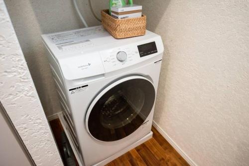 a washing machine with a basket on top of it at villa modama in Nanjo