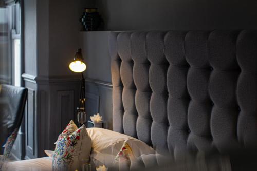 a headboard of a bed in a bedroom at Escape Boutique B&B in Llandudno