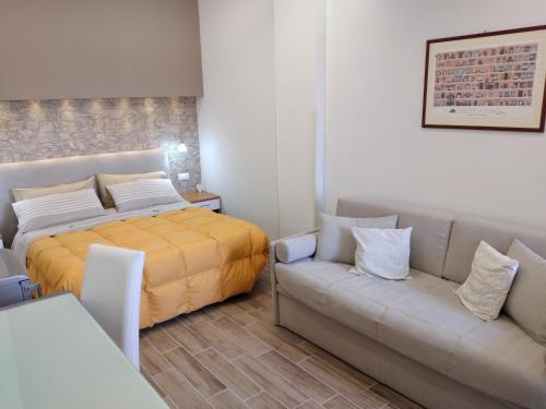 a bedroom with a bed and a couch at B&B Villa Letizia in Castelbuono