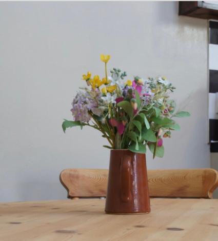 a vase of flowers sitting on top of a table at Arrowwood Self Catering (Wagtail and Nuthatch) in Kington