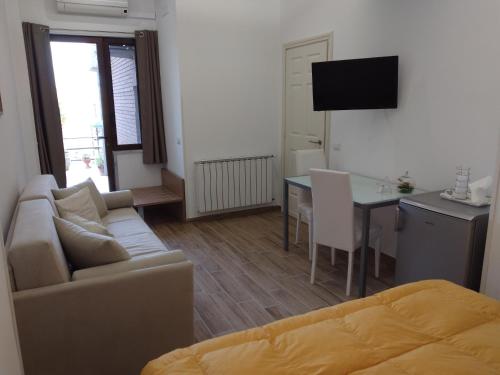 a living room with a couch and a table at B&B Villa Letizia in Castelbuono
