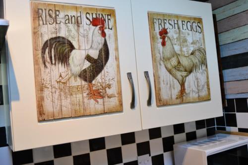 three pictures of chickens hanging on a wall at Arrowwood Self Catering (Wagtail and Nuthatch) in Kington