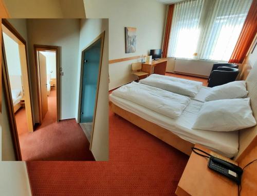 a hotel room with a bed and a mirror at Parkhotel Kevelaer in Kevelaer
