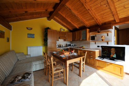 a kitchen with a table and a dining room at Borgo La Sorgente - Erica in Gravedona