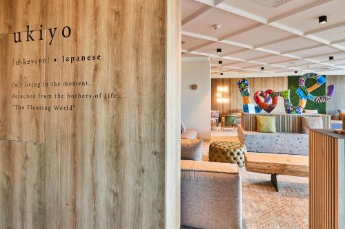 a lobby with a sign that reads viktorleton experience at Victoria Hotel & Residence in Villars-sur-Ollon