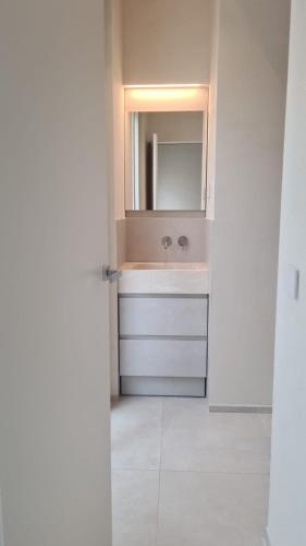 a bathroom with a sink and a mirror at Lido Mare by Massi in Lido di Camaiore