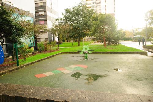 a park with a bench in the middle of a parking lot at New : Grand T4 Cosy et tout équipé in Créteil