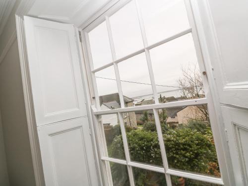 an open window with a view of a building at Belmont in Penzance
