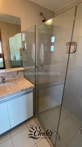 a bathroom with a shower and a sink at Chalé com piscina privada vista mar-Zumbi-RN in Rio do Fogo
