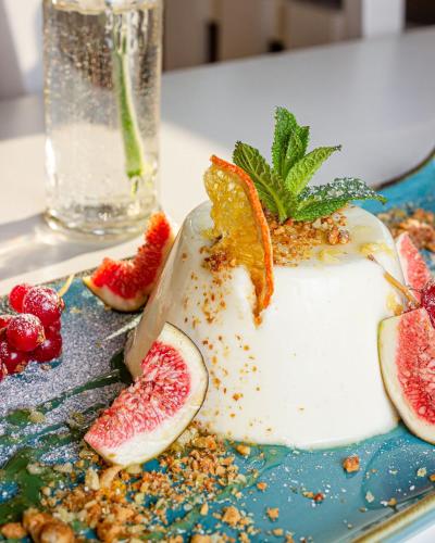 a plate with a slice of fruit and a knife at Hotel Omega in Moers