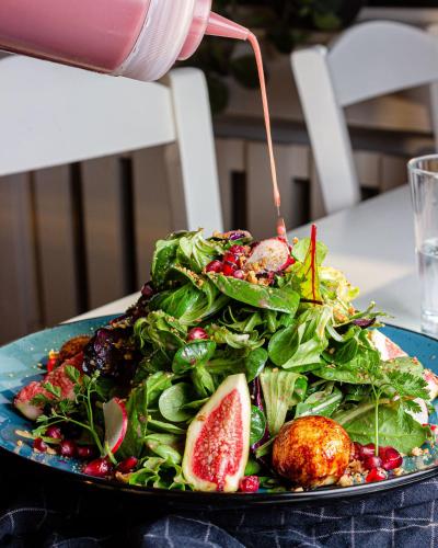 a plate of food with a salad on a table at Hotel Omega in Moers