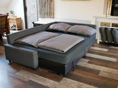a bed with two pillows on it in a room at Apartman Vulcano in Zvolen