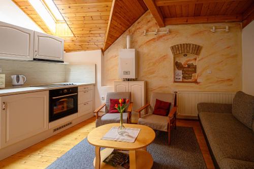 a kitchen and living room with a couch and a table at Nádasdi Ház in Szekszárd