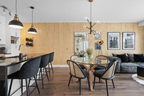 a kitchen and living room with a glass table and chairs at INITIAL -CLASSE S- Centre-ville de Québec +stationnement in Quebec City