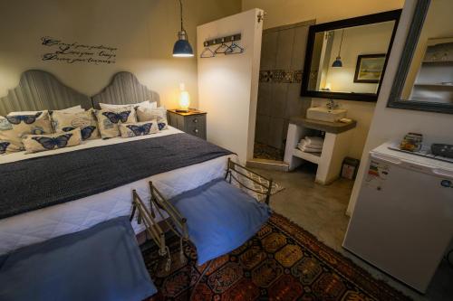 a bedroom with a large bed and a mirror at Rose Acres Guest House in Parys