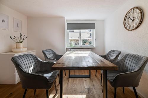 a dining room with a wooden table and chairs at FEWO Im alten Fachwerkhaus in Bad Buchau
