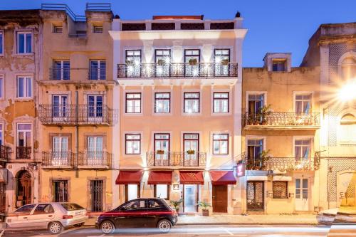 a building with cars parked in front of it at Lisbon Wine House - Rooms & Suites in Lisbon