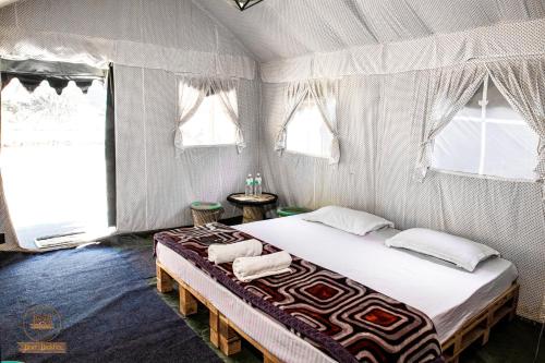 a bedroom with a large bed in a tent at Riverside Swiss Camps "Adventure Bear Buddies" in Rishīkesh