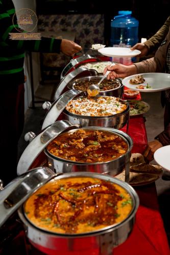 a table topped with lots of different types of food at Riverside Swiss Camps "Adventure Bear Buddies" in Rishīkesh