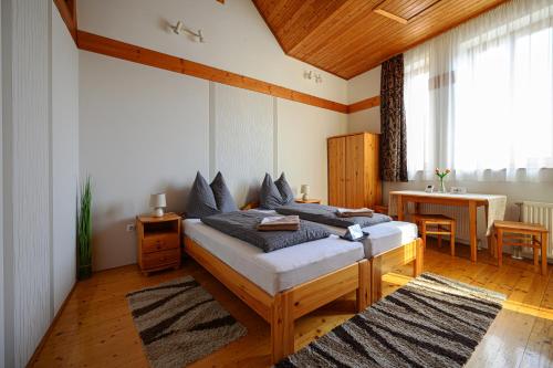 a bedroom with two beds and a desk in it at Nádasdi Ház in Szekszárd