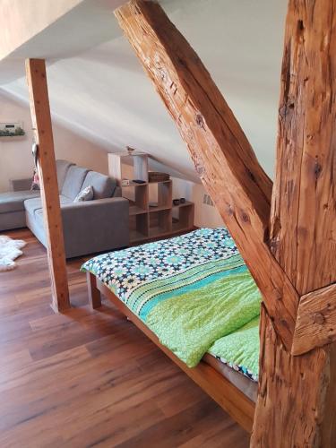 a bed with a wooden frame in a room at Apartmán Sýkorka in Hartmanice