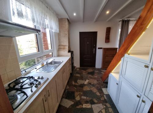 a kitchen with a sink and a stove at Domek blisko granicy u Darka in Kunowice