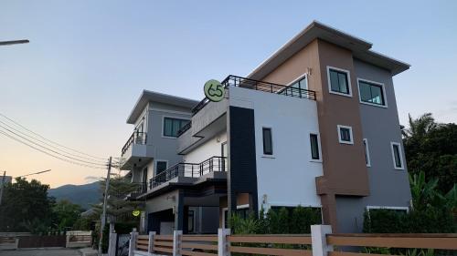 a building with a clock on the side of it at 65 hostel chiangmai in Chiang Mai