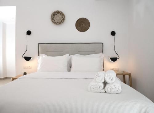 a bedroom with a bed with towels on it at IADES suites in Afitos
