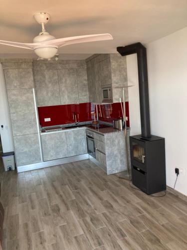 a kitchen with red cabinets and a stove at Beach Side Apartments Calahonda in Sitio de Calahonda