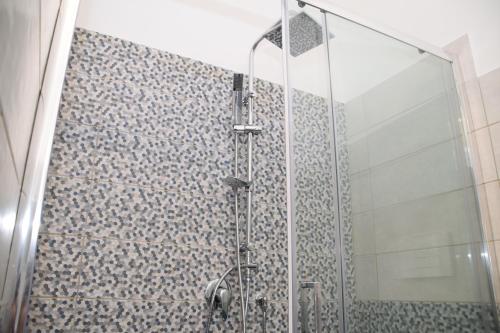 a bathroom with a shower with a glass wall at Casetta Verga Loft in Catania