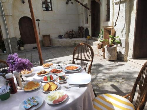 a table with plates of food on it at ARMEsos Cave Hotel in Ürgüp