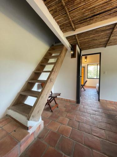 a staircase in a room with a brick floor at Hotel Casas de Campo El Ciruelo in San Gil