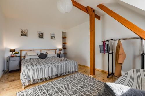 a bedroom with two beds and a surfboard at SuperApart Sopot Centrum in Sopot