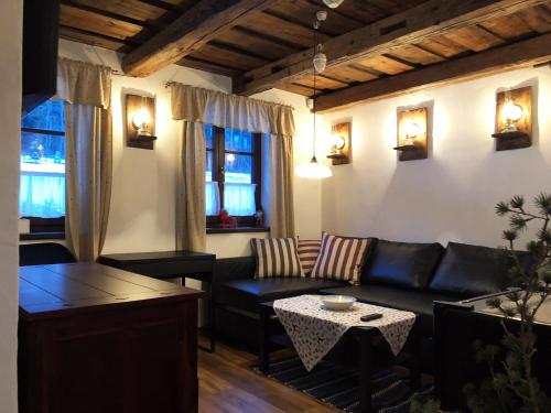a living room with a couch and a table at Kazmarka in Malá Morávka
