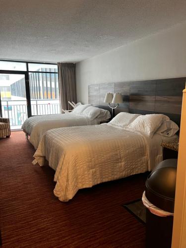 a hotel room with two beds and a large window at Landmark Resort in Myrtle Beach