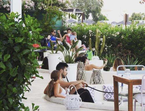 a group of people sitting on a patio at Blue Peter Apartments in Protaras