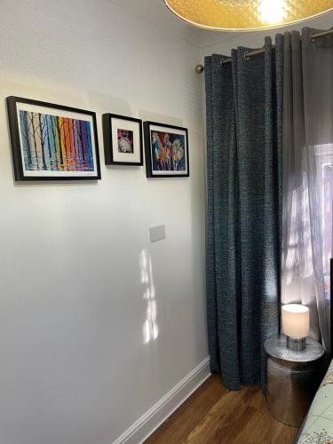 a room with pictures on the wall and a window at The Annexe @The Oaks in Golden Valley