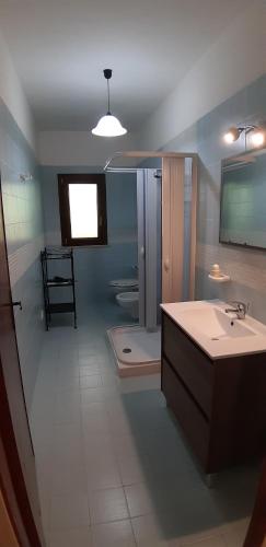 a bathroom with a sink and a bath tub at La Torretta in Favignana