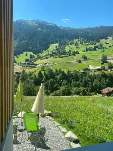 a couple of umbrellas and chairs on a hill at Villa Smilla in Gaschurn