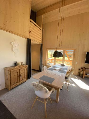 a dining room with a wooden table and chairs at Villa Smilla in Gaschurn