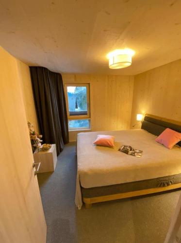 a bedroom with a bed and a window at Villa Smilla in Gaschurn