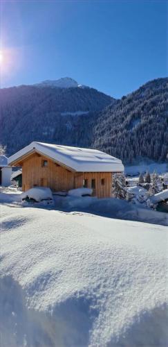 a building with snow on the ground in front at Villa Smilla in Gaschurn