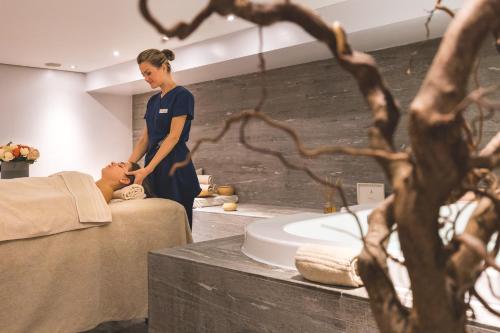 a woman standing next to a man in a bathroom at Villa Sassa in Lugano