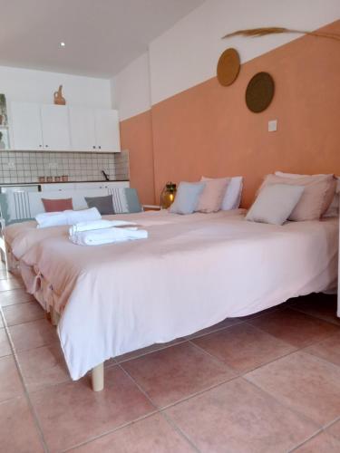 a large white bed sitting in a room at Blue Peter Apartments in Protaras
